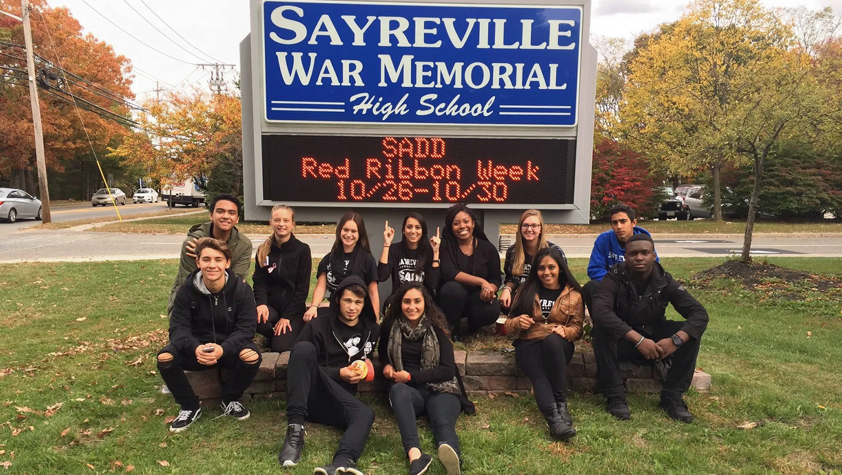 Sayreville Students in front of school sign